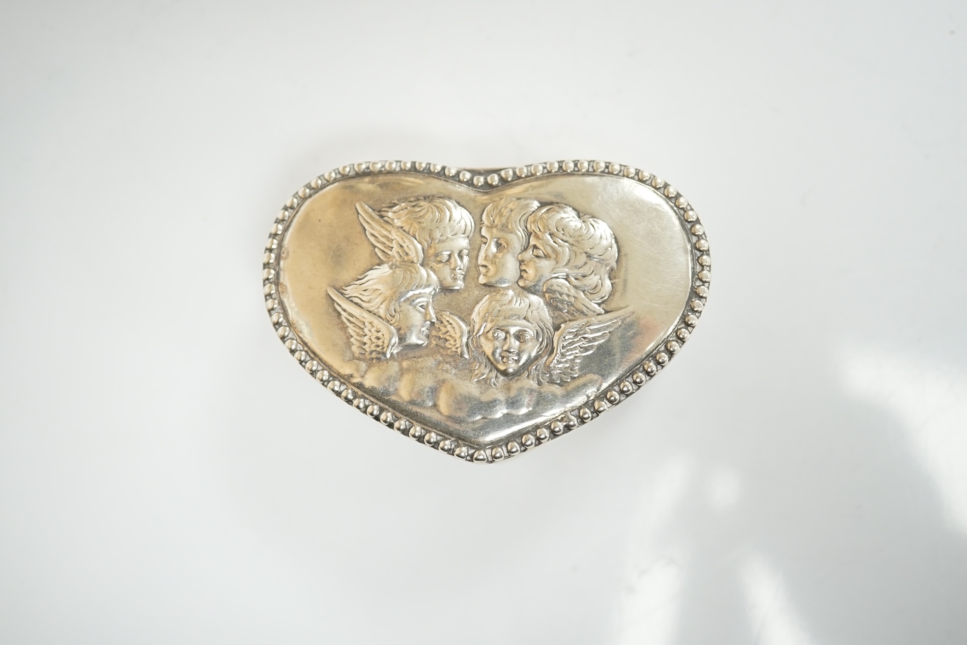 A group of assorted silver including a George III Irish silver basing spoon, Dublin, 1804, 29.5cm, a similar sauce ladle, two Georgian berry spoons, a late Victorian heart shaped photograph frame, a heart shaped pill box